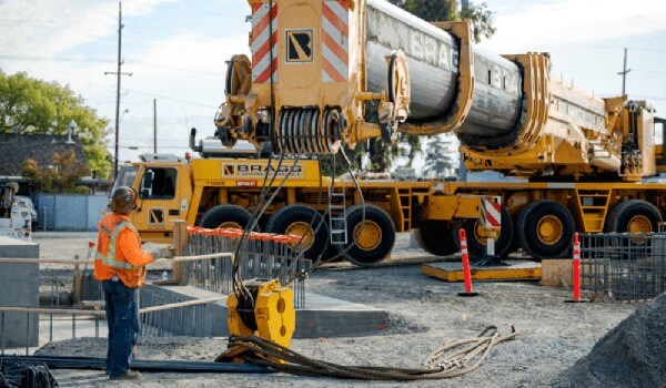 crews installing electrification infrastructure for Caltrain