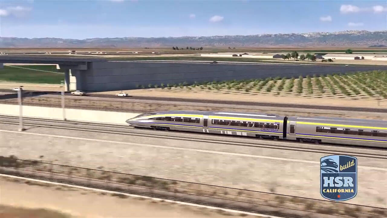 Still from video showing a simulation of high-speed rail cars approaching a grade separation.
