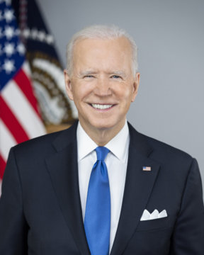 official portrait of President Joe Biden standing in front of US flag